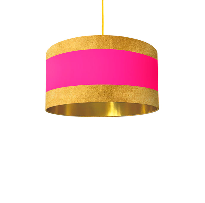 lampshade boasts a unique combination of gold stripes at the top and bottom, framing a captivating pink center.