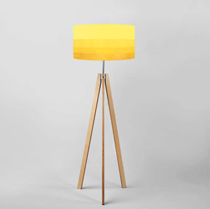 Gradient yellow-gold drum lampshade on tripod floor lamp, diameter 40cm, modern and elegant design for contemporary interiors.