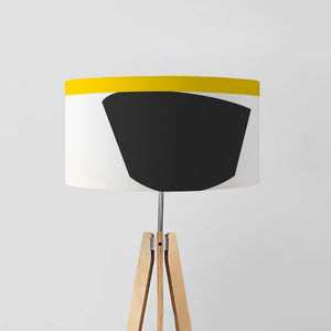 "Abstract Light" drum lampshade features a contemporary geometric design with playful use of shapes and lines in shades of black, white, and yellow